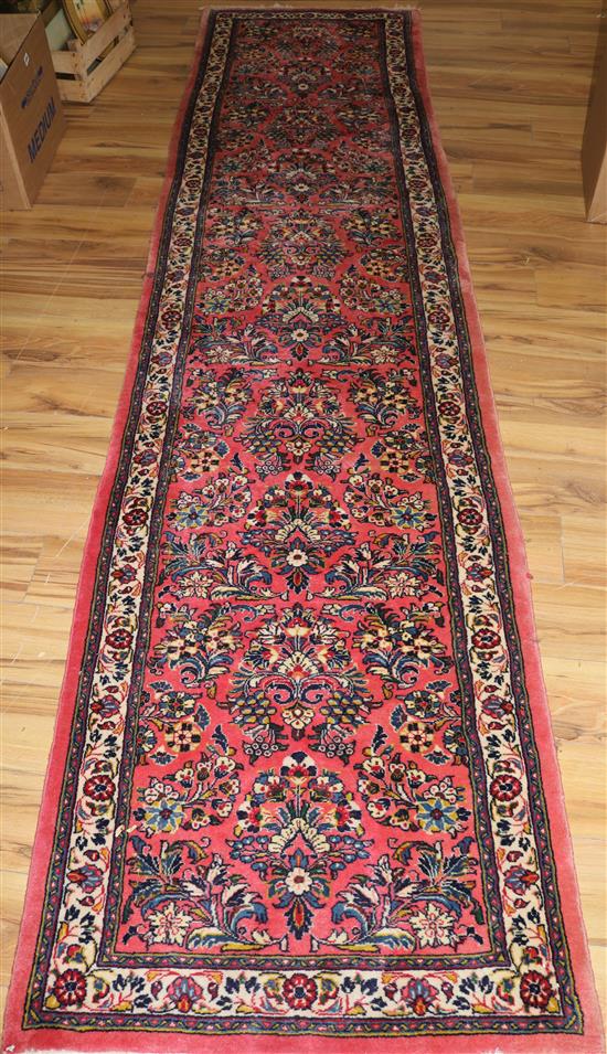 A Persian red ground runner, 11ft by 2ft 8in.